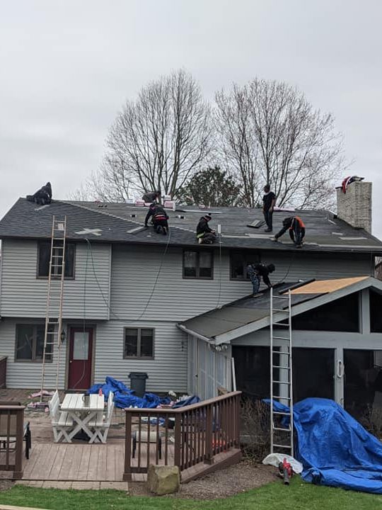 US Window Door & More contractors installing a new roof on a home.