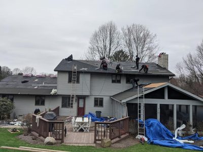 US Window Door & More contractors installing a new roof on a home.